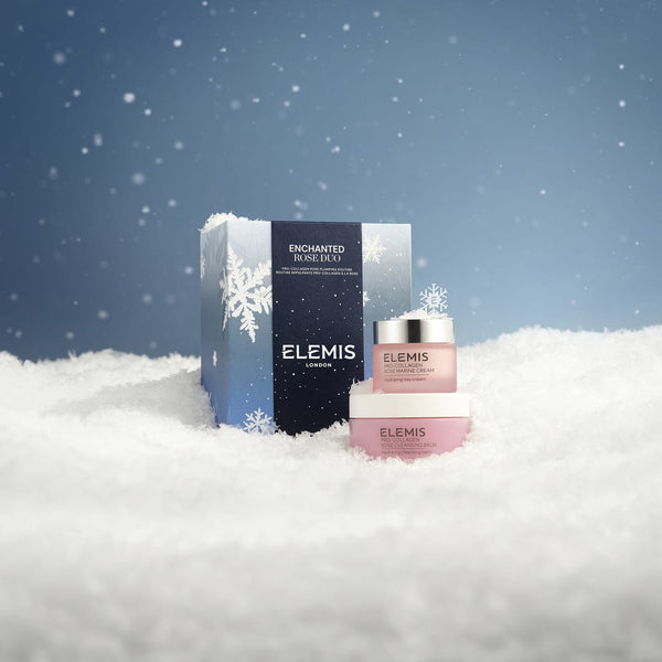 Elemis skincare products in the snow with a blue sky background