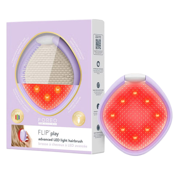 FOREO FLIP play advanced LED light hairbrush shown next to its lavender packaging box on a white background.