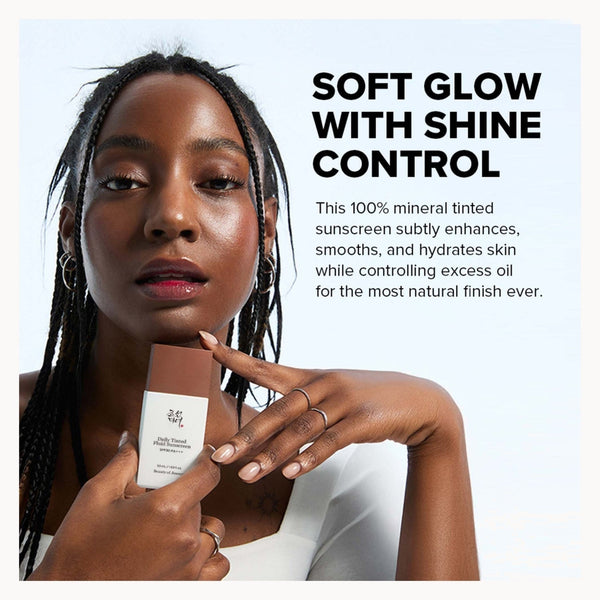 A promotional beauty ad featuring a woman with braided hair holding a bottle of UGG tinted sunscreen, with text on the right reading 'SOFT GLOW WITH SHINE CONTROL' and product benefits.