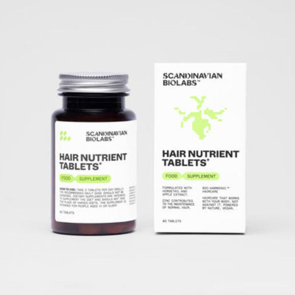 A dark amber bottle and matching white box of Scanynavian Biolabs Hair Nutrient Tablets, shown on a clean light gray background.