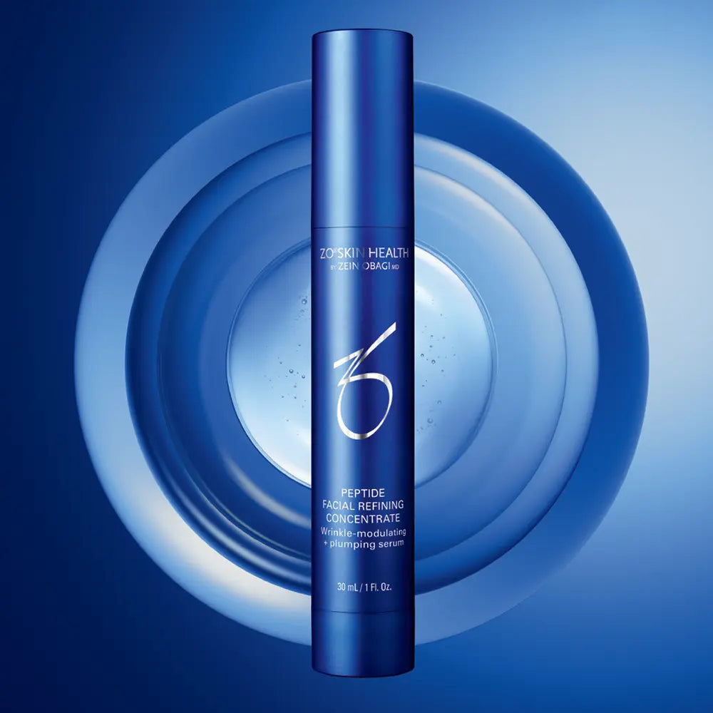Blue skincare serum bottle with brand logo on a blue background