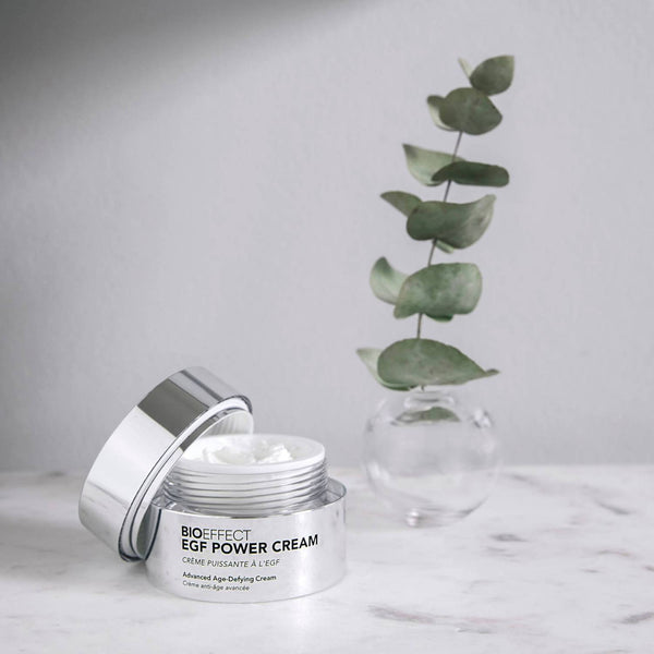 BIOEFFECT EGF Power Cream with an open lid and a tall plant behind it