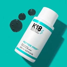 K18 PEPTIDE PREP Detox Shampoo with three drops of shampoo next to the bottle