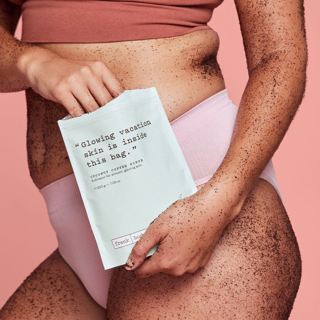 a closeup of a womens body with the coffee scrub applied