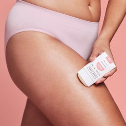 a person using a Frank Body Glide 'N' Go Body Oil Stick on their leg