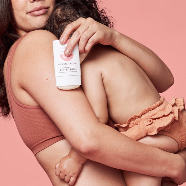 a women holding  a stick of Frank Body Glide 'N' Go Body Oil