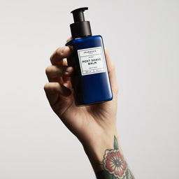 a hand holding the bottle into the air